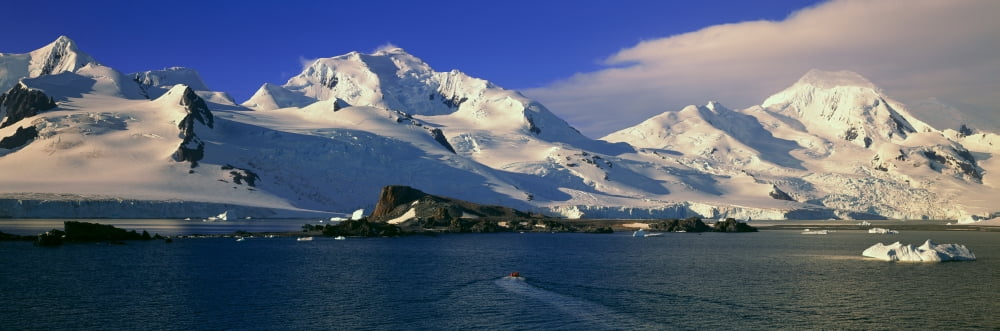 Panoramic view of ecological tourists in inflatable Zodiac boats snowy mountains glaciers and icebergs at Half Moon Island Bransfield Strait Antarctica Canvas Art - Panoramic Images (36 x 12)