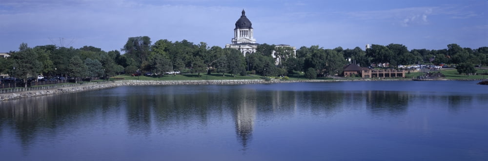 Panoramic view of lake with view of South Dakota State Capitol and complex Pierre South Dakota built between 1905 and 1910 Canvas Art - Panoramic Images (36 x 12)