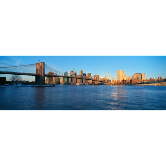 Panoramic view of Brooklyn Bridge and East River at sunrise with New York City, where World Trade Towers were located, NY Poster Print (36 x 12)