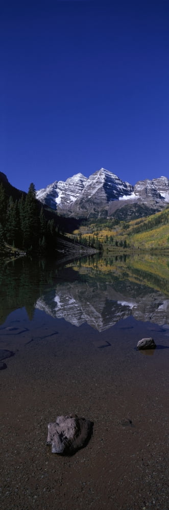 Panoramic view of autumn colors of Aspens reflecting in lake under Maroon Bells Colorado near Aspen Canvas Art - Panoramic Images (27 x 9)