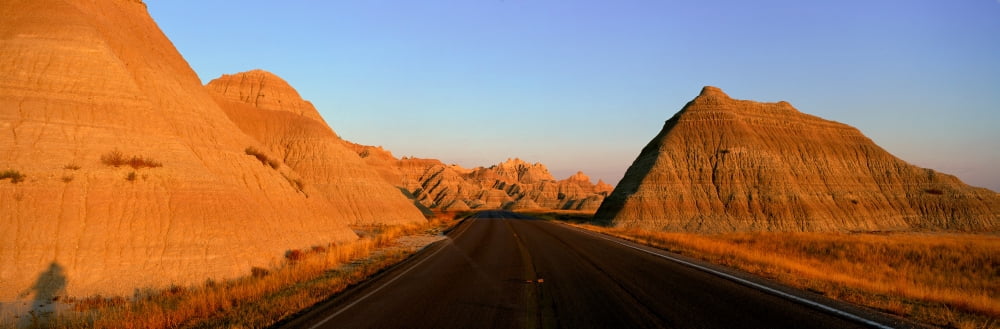 Panoramic view of road going through Badlands National Park in South Dakota Canvas Art - Panoramic Images (27 x 9)