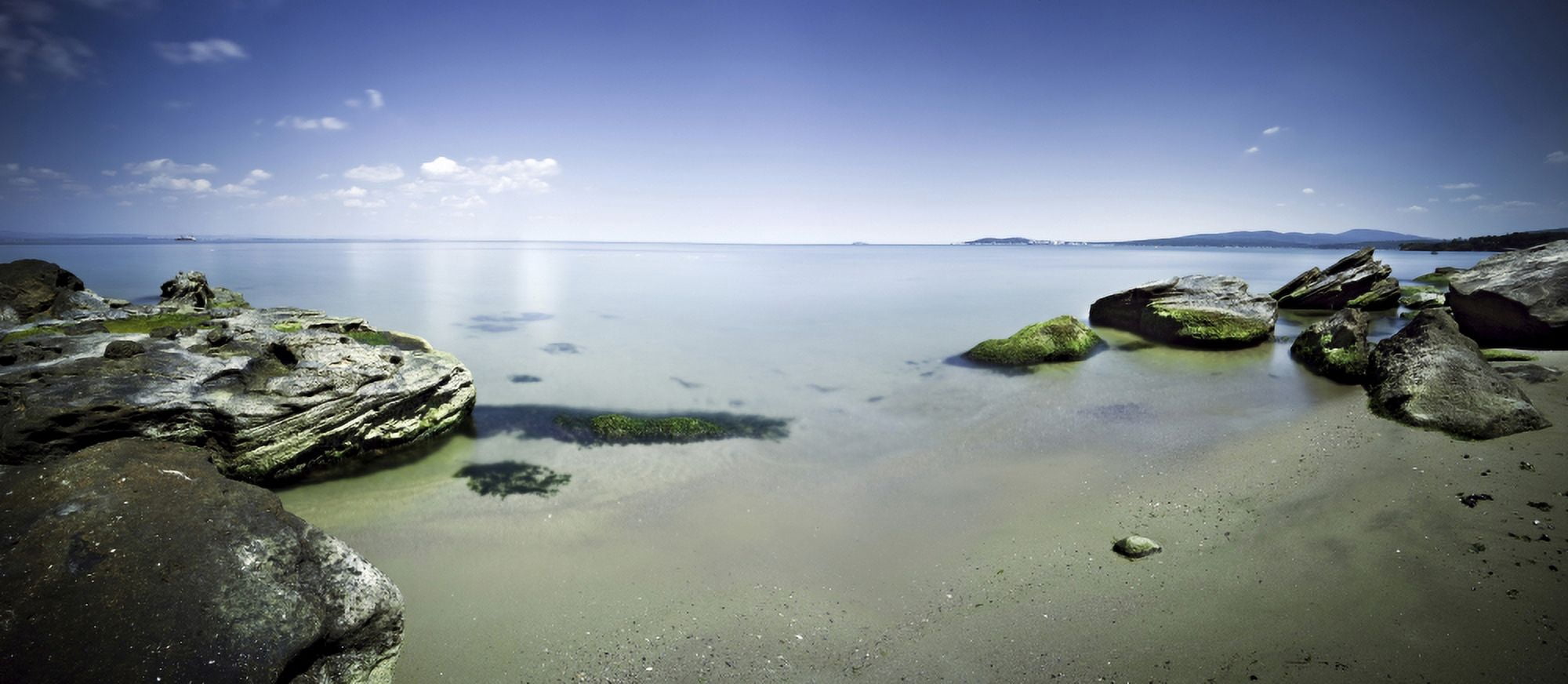 Panoramic view of tranquil sea and boulders against blue sky Burgas Bulgaria Canvas Art - Evgeny KuklevStocktrek Images (22 x 10)