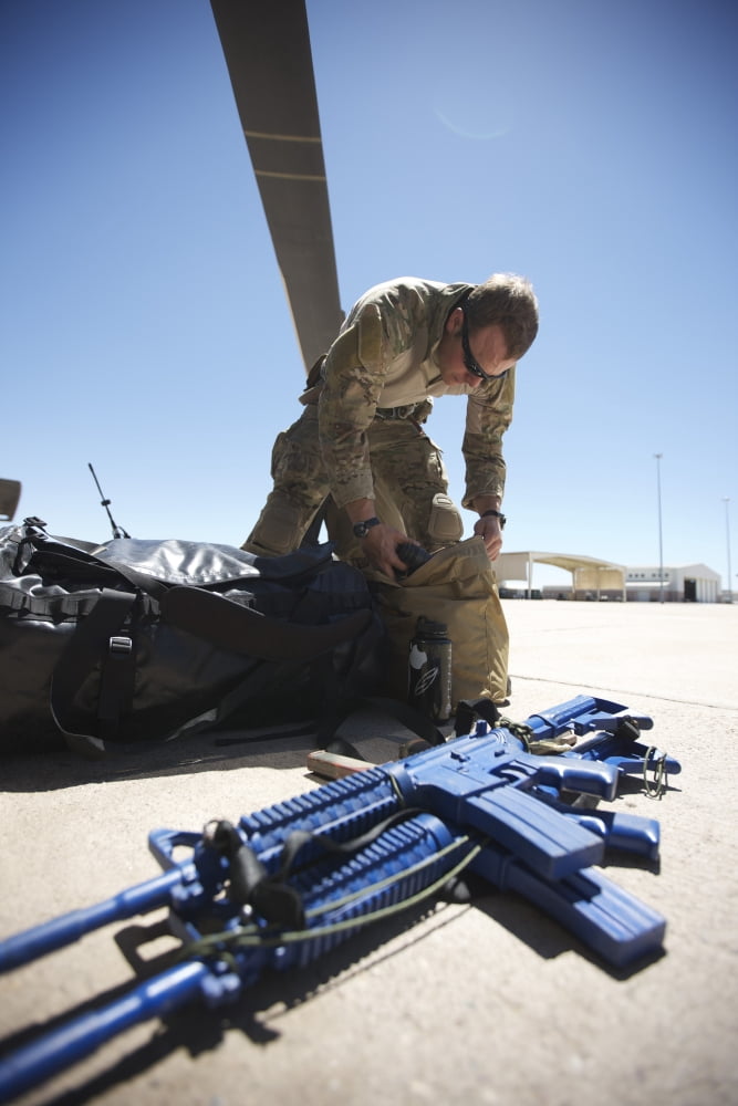 Pararescuemen sorts out his gear before a mission Canvas Art - Terry MooreStocktrek Images (12 x 18)