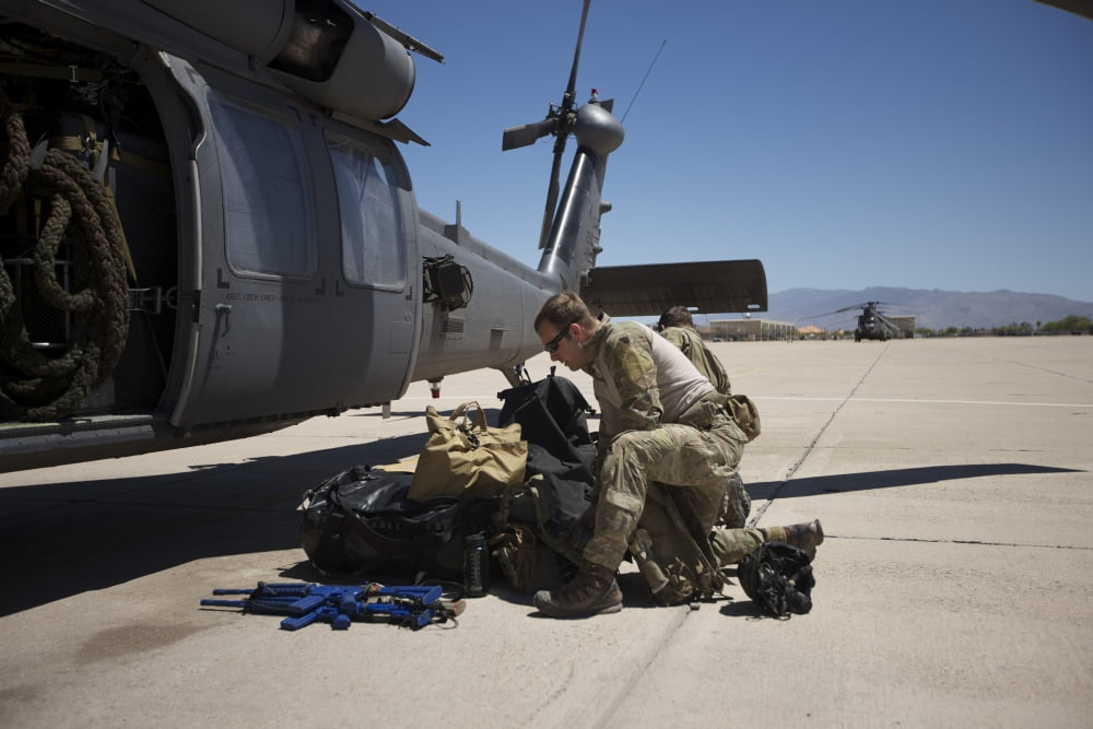 Pararescuemen sorts out his gear before a mission Canvas Art - Terry MooreStocktrek Images (18 x 12)