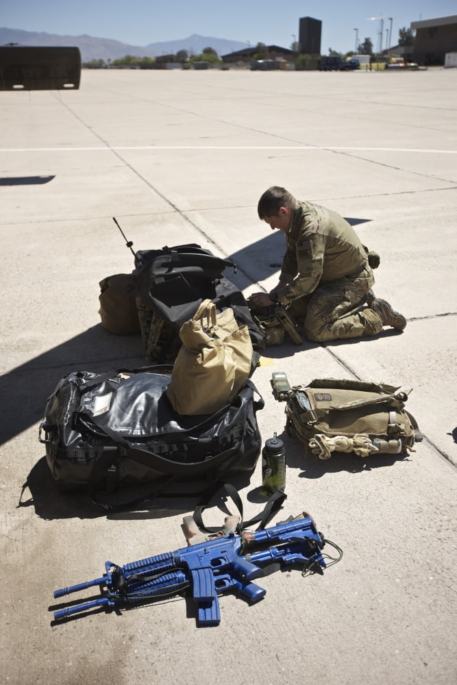 Pararescuemen sorts out his gear before a mission Canvas Art - Terry MooreStocktrek Images (23 x 35)