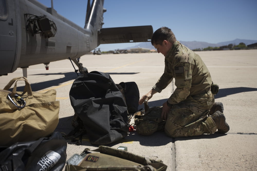 Pararescuemen sorts out his gear before a mission Canvas Art - Terry MooreStocktrek Images (35 x 23)