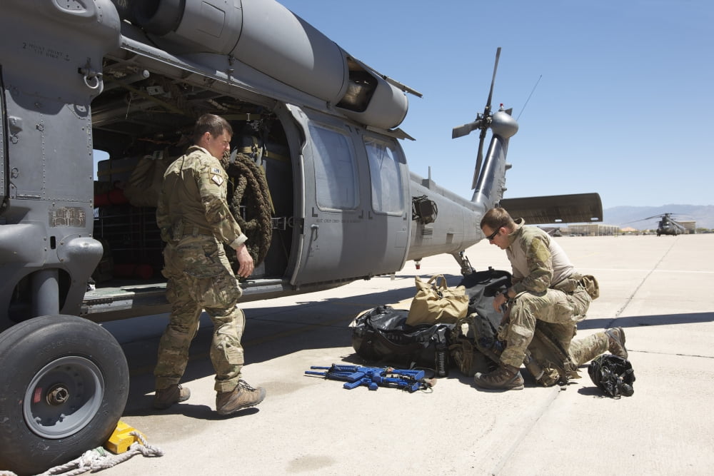 Pararescuemen sorts out his gear before a mission Canvas Art - Terry MooreStocktrek Images (35 x 23)