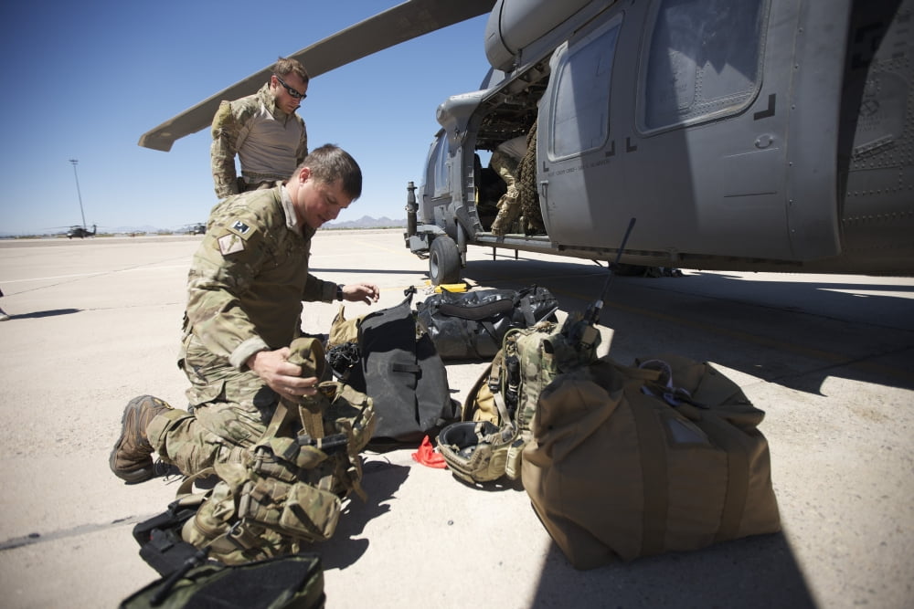 Pararescuemen sorts out his gear before a mission Canvas Art - Terry MooreStocktrek Images (35 x 23)