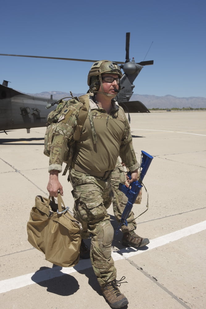 Pararescuemen walks away from a HH-60G Pave Hawk Canvas Art - Terry MooreStocktrek Images (23 x 35)