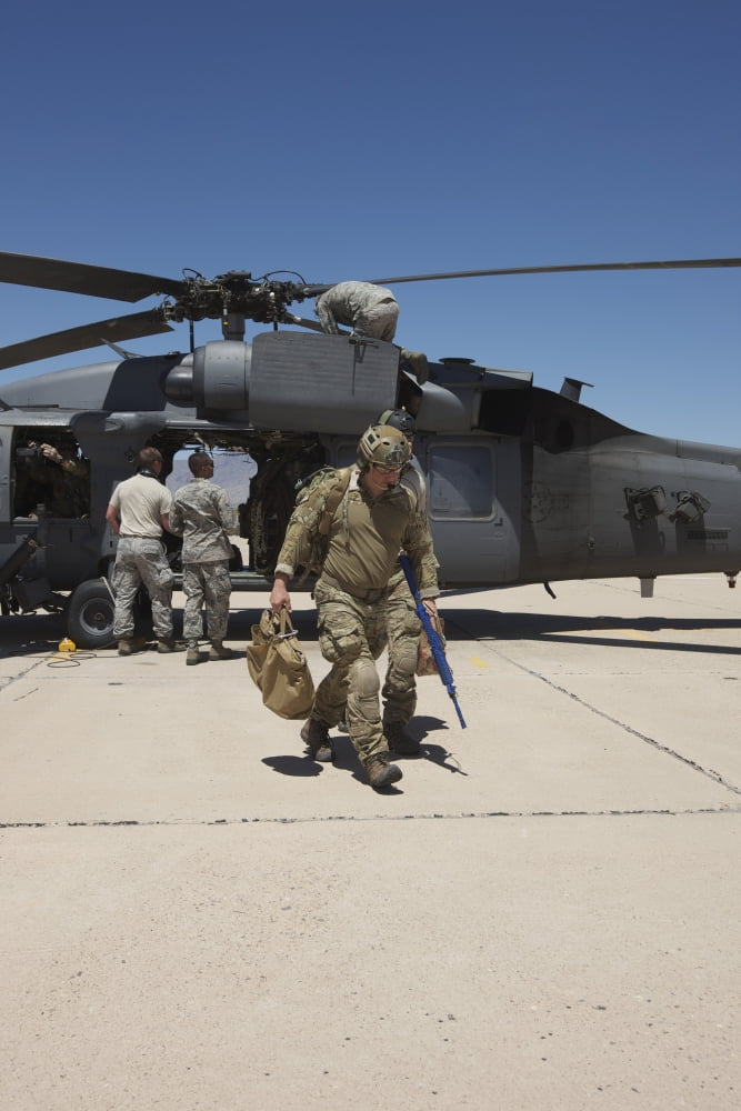 Pararescuemen walks away from a HH-60G Pave Hawk Canvas Art - Terry MooreStocktrek Images (23 x 35)
