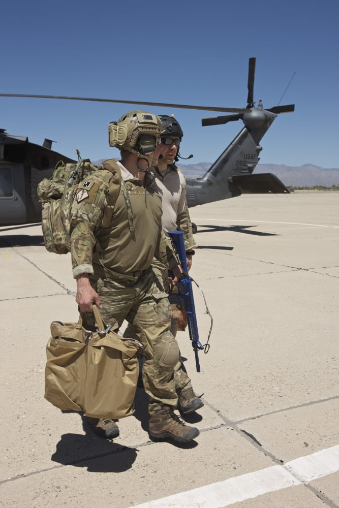 Pararescuemen walks away from a HH-60G Pave Hawk Canvas Art - Terry MooreStocktrek Images (23 x 35)