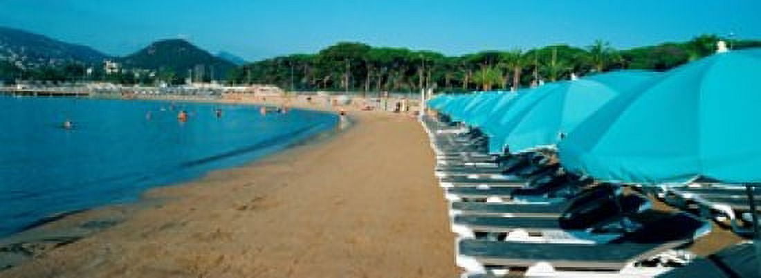 Parasols with lounge chairs on a private beach in summer morning light French Riviera Provence-Alpes-Cote dAzur France Canvas Art - Panoramic Images (18 x 7)