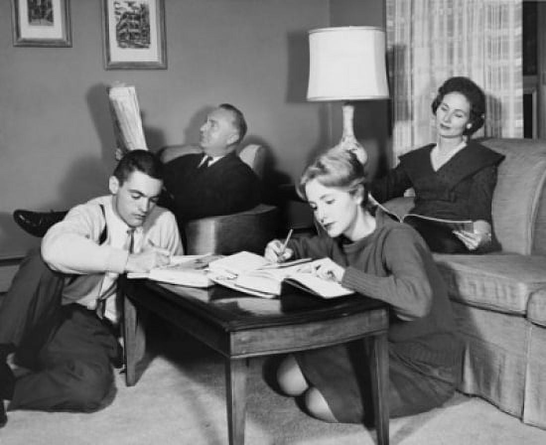 Parents and adult children reading in living room Canvas Art - (24 x 36)