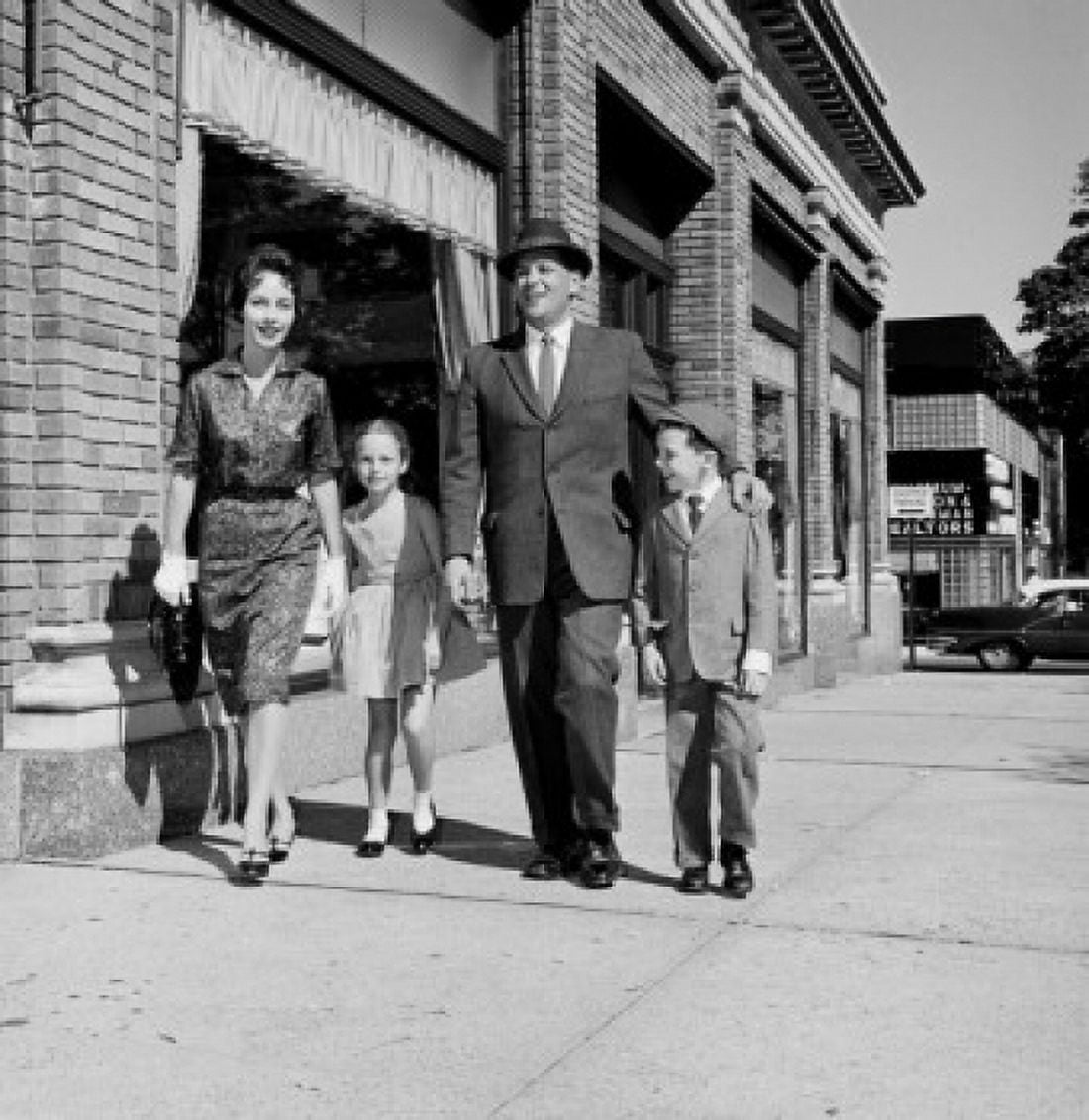 Parents and kids walking down street Canvas Art - (18 x 24)