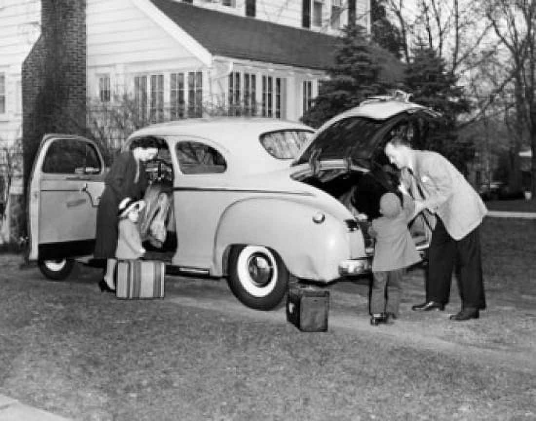 Parents and their children loading luggage into a car Canvas Art - (18 x 24)