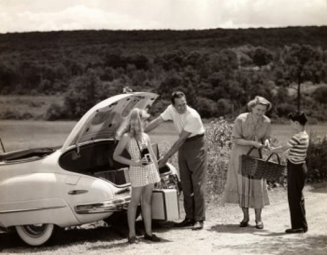 Parents and their children loading luggage into a car Canvas Art - (18 x 24)