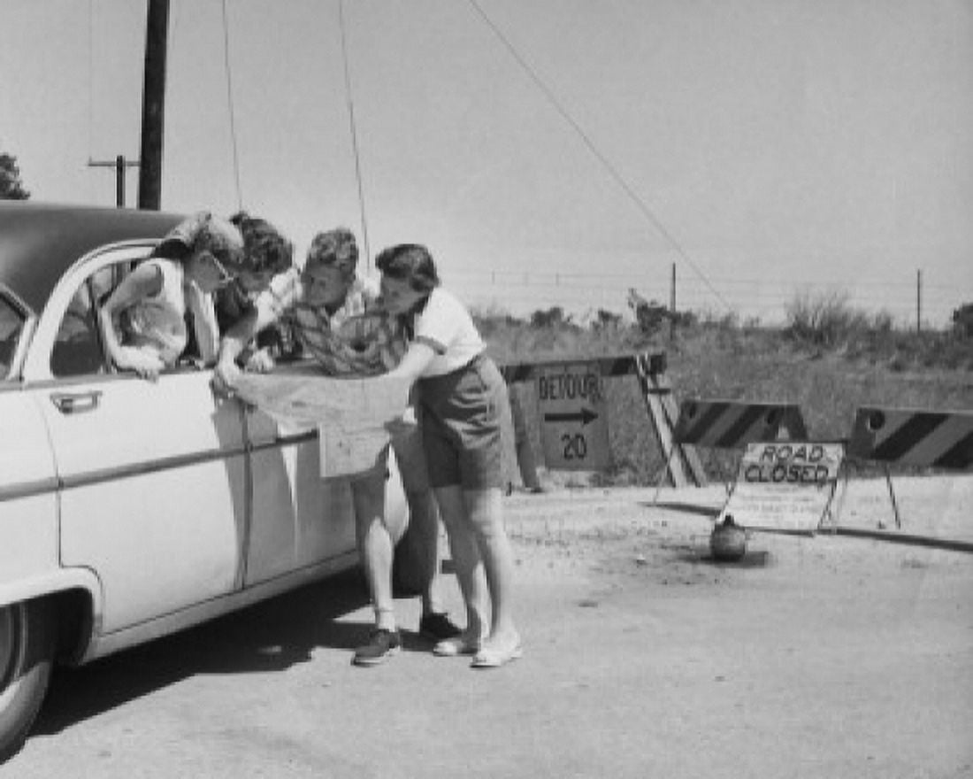 Parents and their children looking at a map near a road closed sign Canvas Art - (24 x 36)