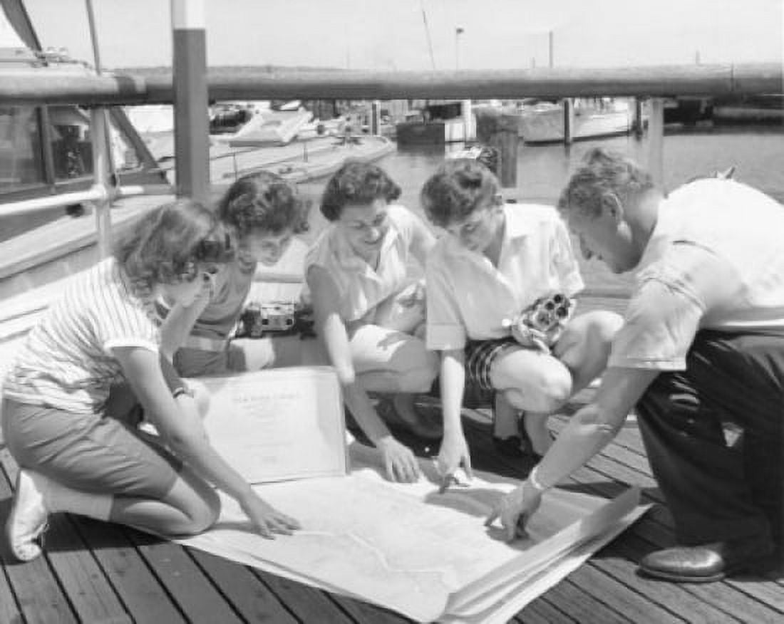 Parents and their children looking at a map on a pier Canvas Art - (24 x 36)