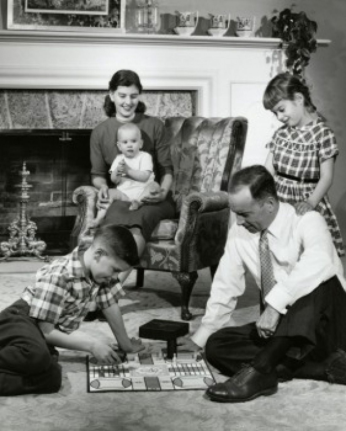 Parents and their children sitting in the living room Canvas Art - (18 x 24)