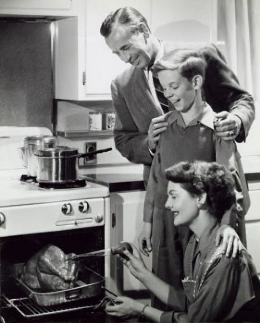 Parents and their son preparing a turkey in the kitchen Canvas Art - (18 x 24)