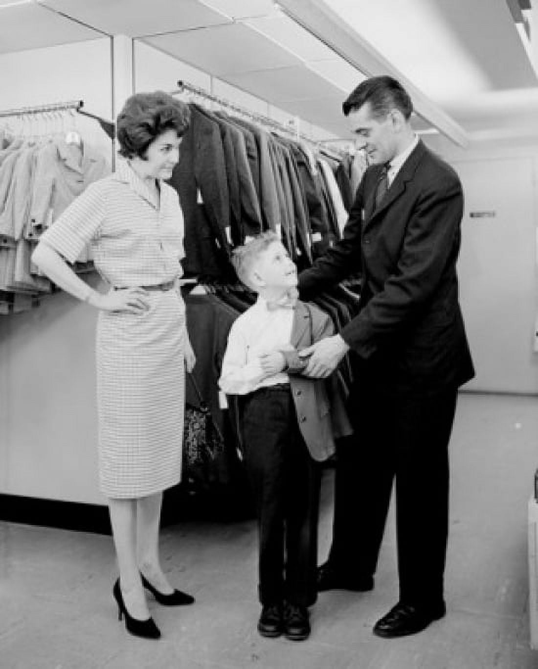 Parents assisting son trying on suit in shop Canvas Art - (18 x 24)