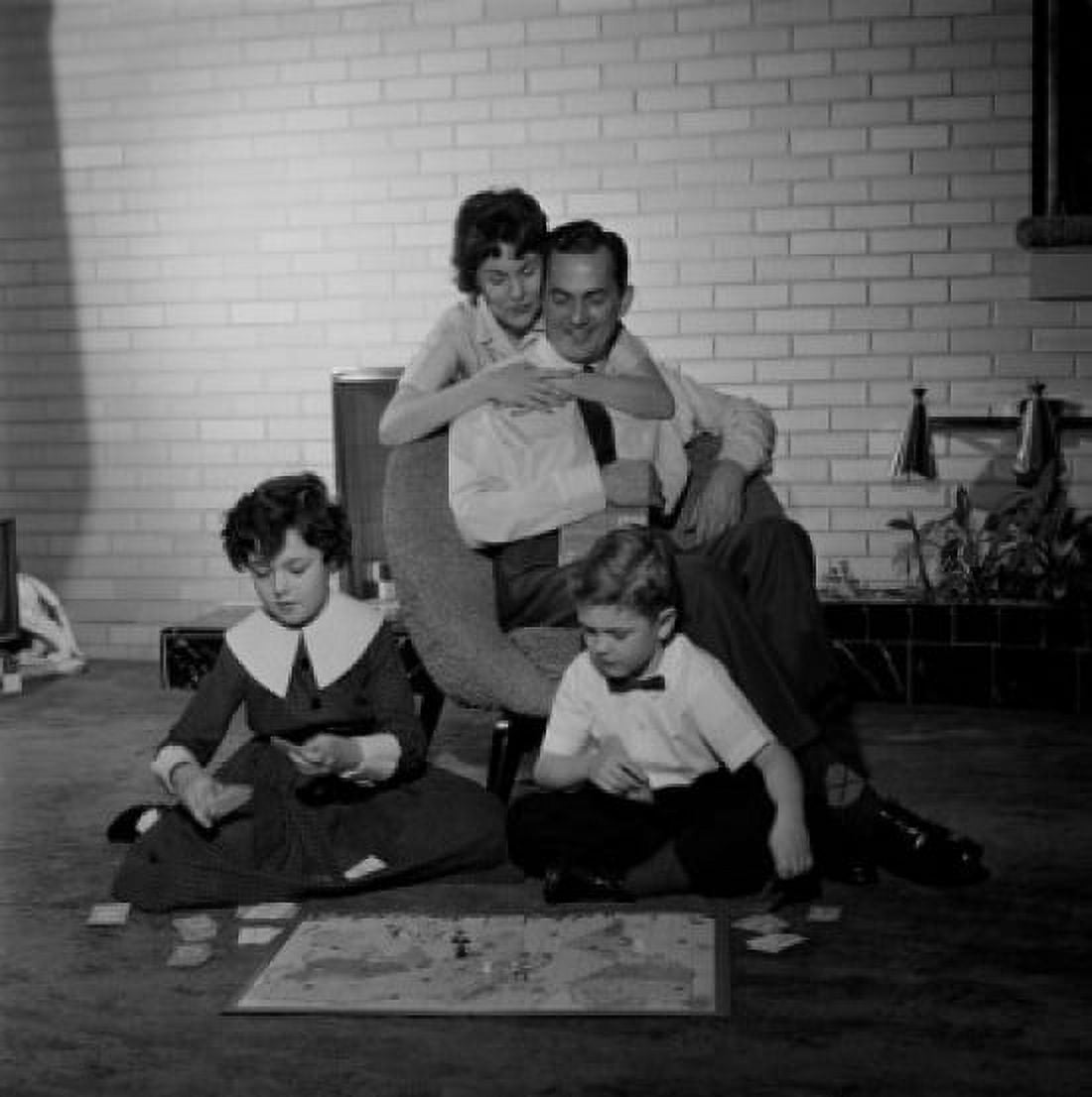 Parents looking at kids playing board game Canvas Art - (24 x 36)