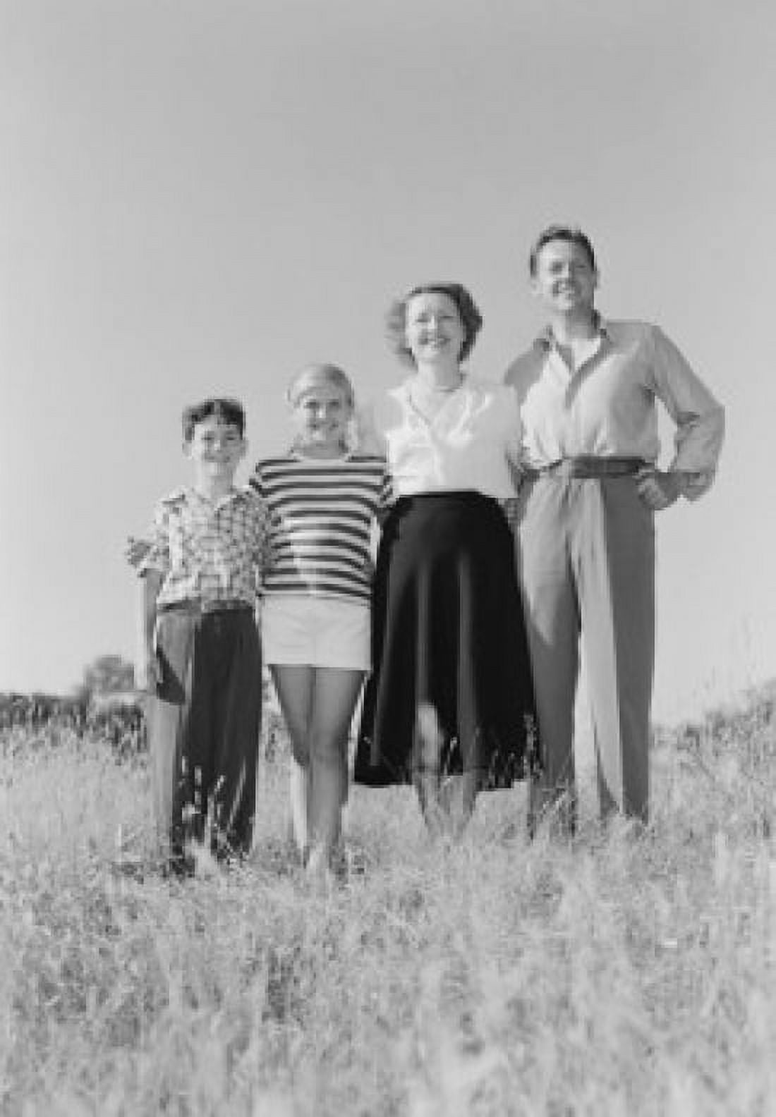 Parents with children standing in meadow Canvas Art - (18 x 24)