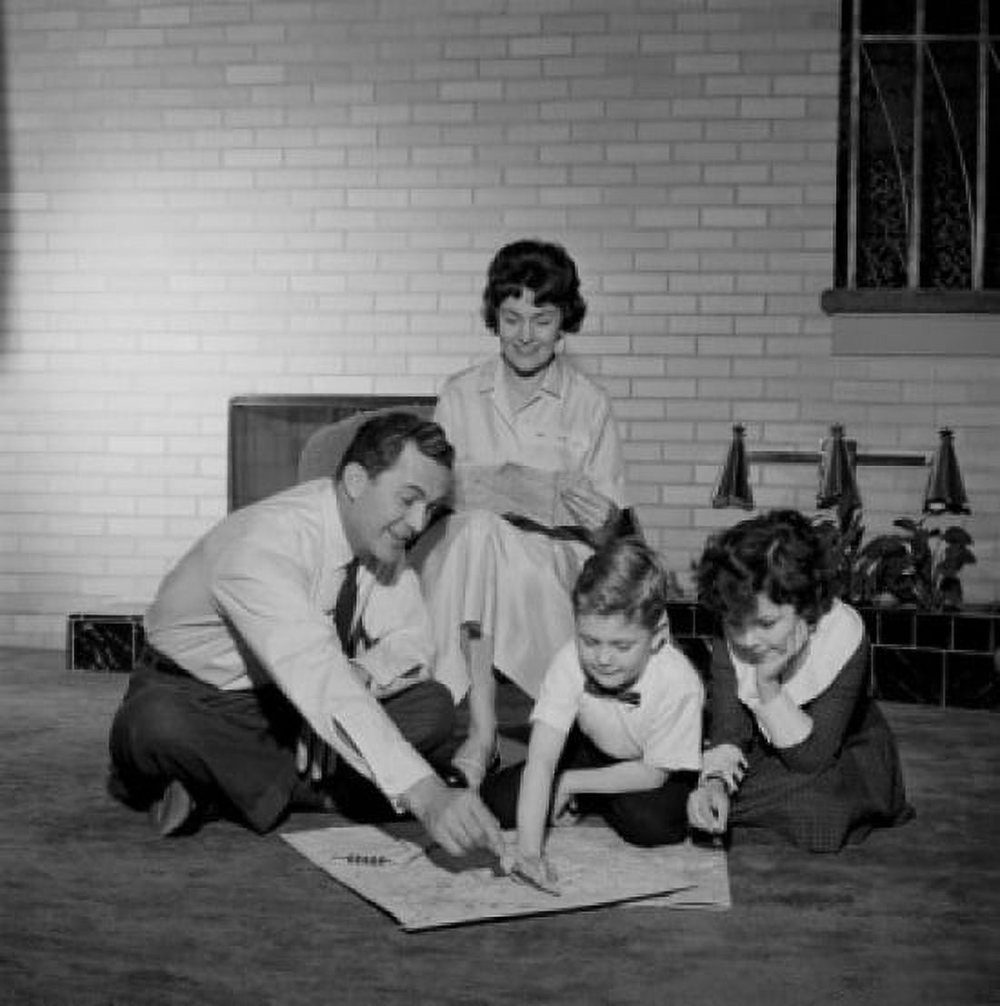 Parents with kids looking at map Canvas Art - (24 x 36)