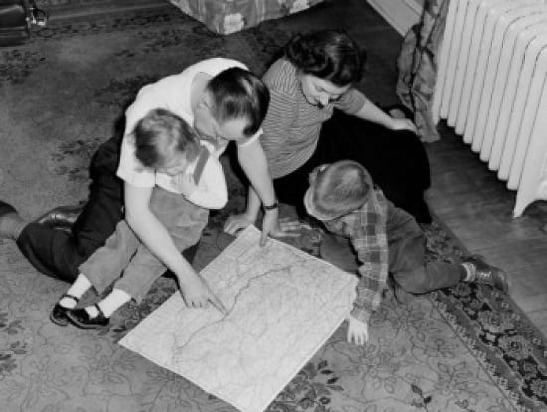 Parents with kids sitting on floor looking at map Canvas Art - (24 x 36)