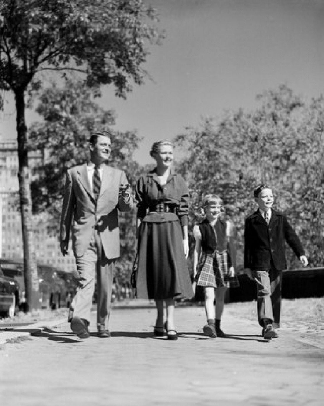 Parents with kids walking through park Canvas Art - (24 x 36)