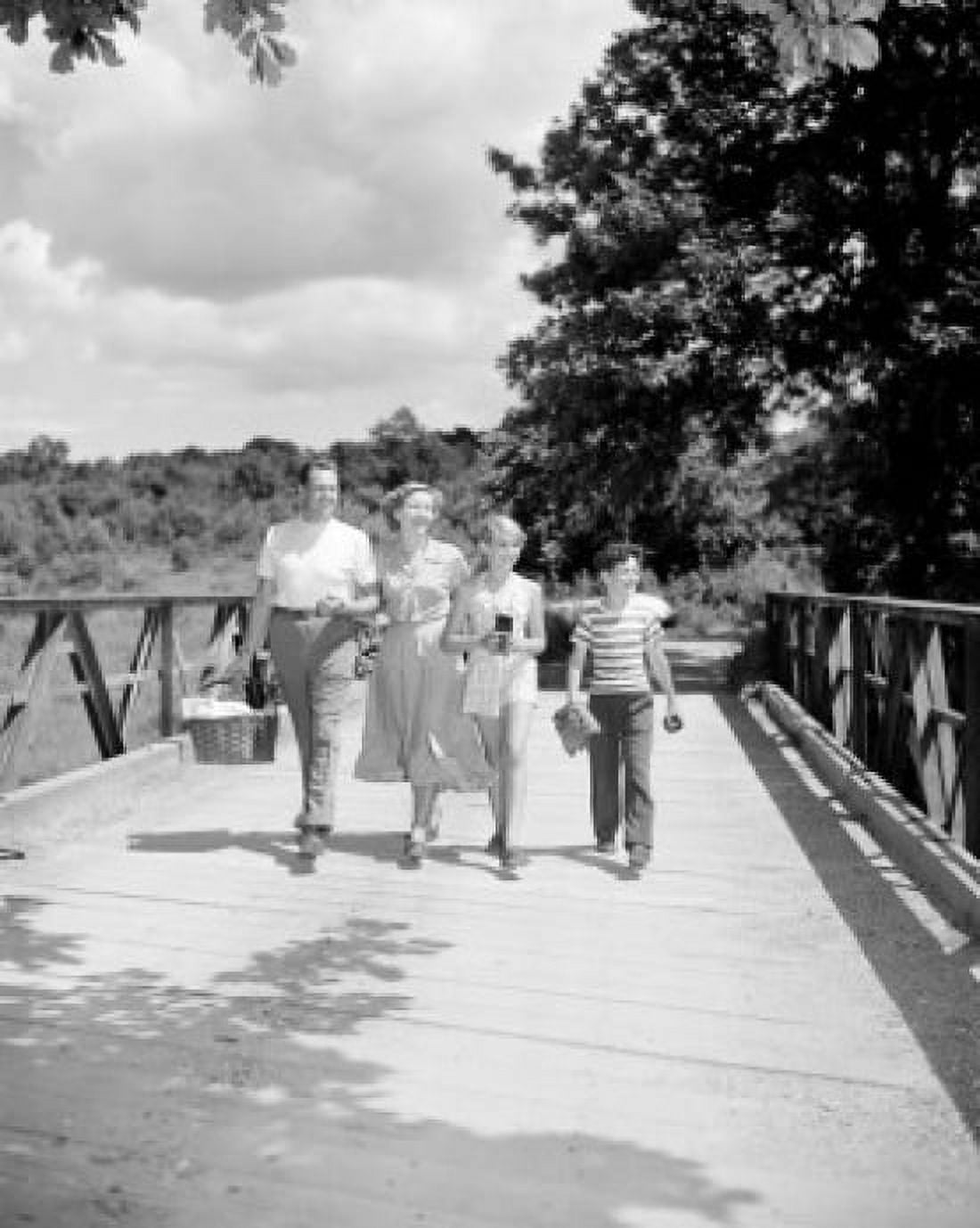 Parents with son and daughter walking on bridge Canvas Art - (18 x 24)