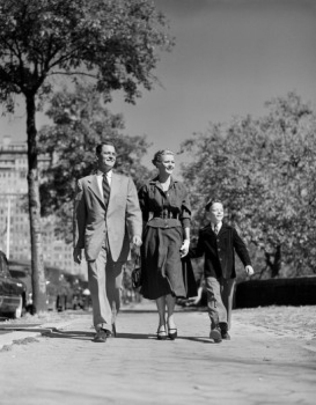 Parents with son walking through park Canvas Art - (18 x 24)