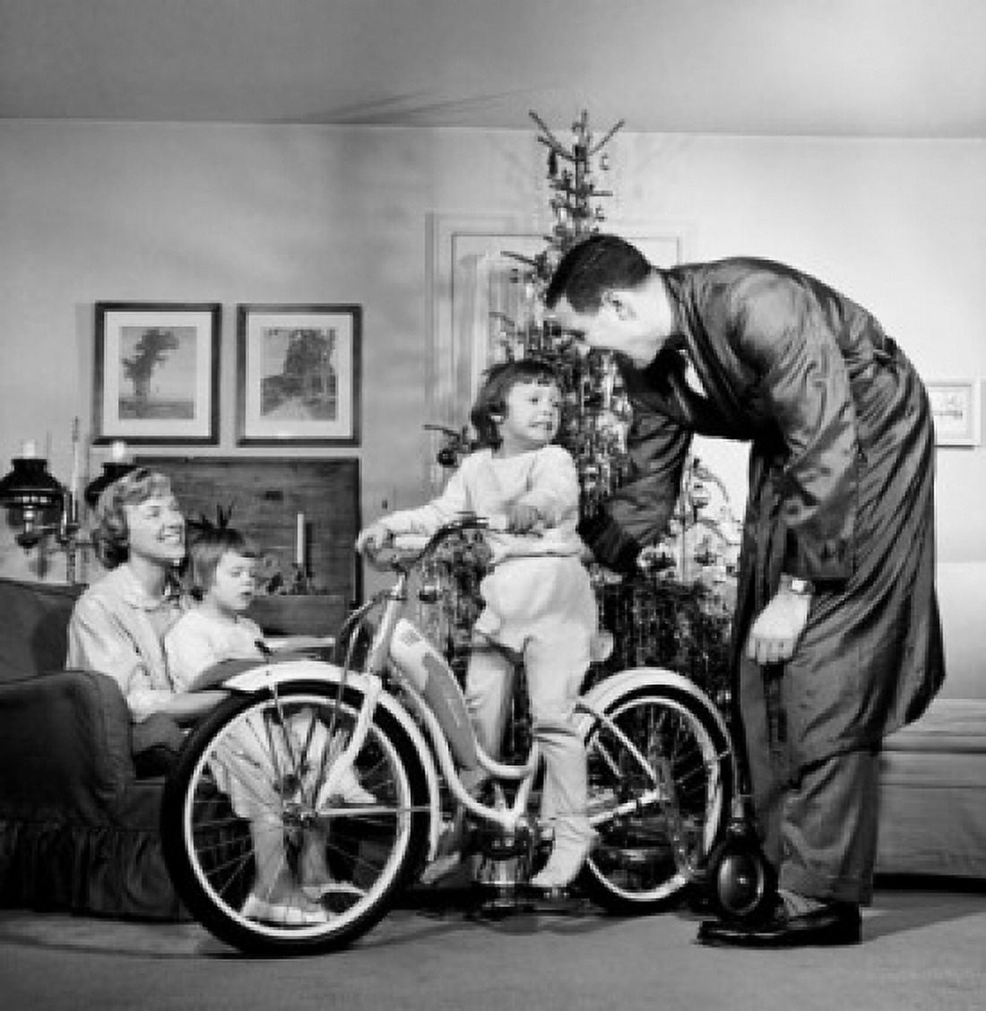Parents with their son and daughter in a living room Canvas Art - (24 x 36)