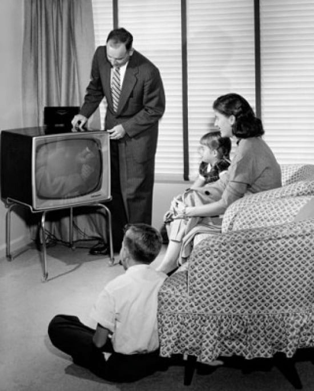 Parents with their two children sitting in front of television Canvas Art - (24 x 36)