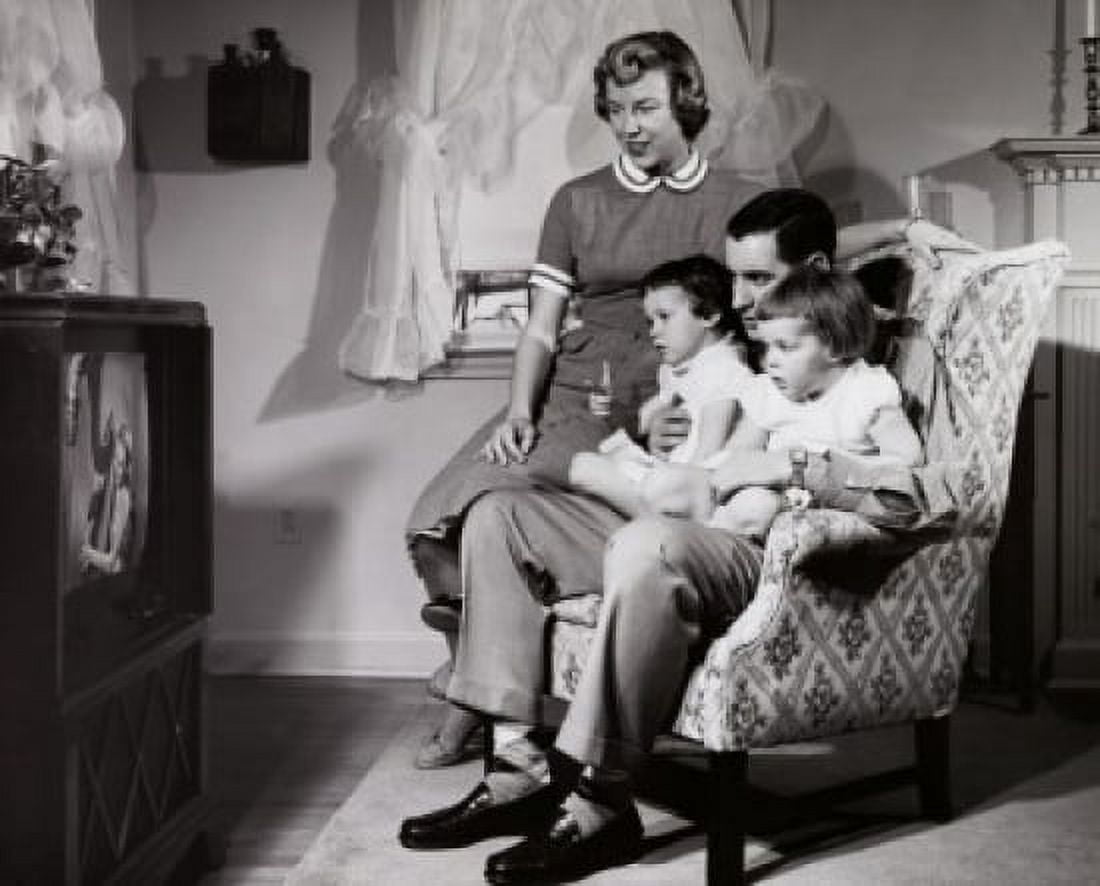 Parents with their two daughters watching television Canvas Art - (18 x 24)