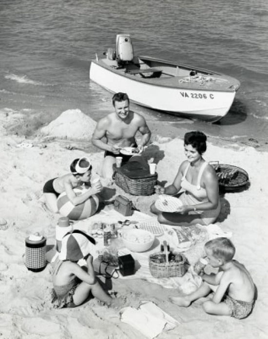 Parents with three children having picnic on beach Canvas Art - (24 x 36)