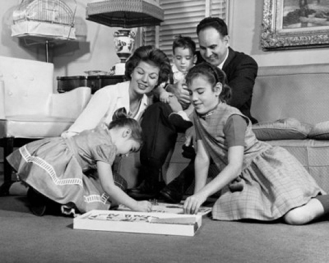 Parents with three children relaxing in living room Canvas Art - (24 x 36)