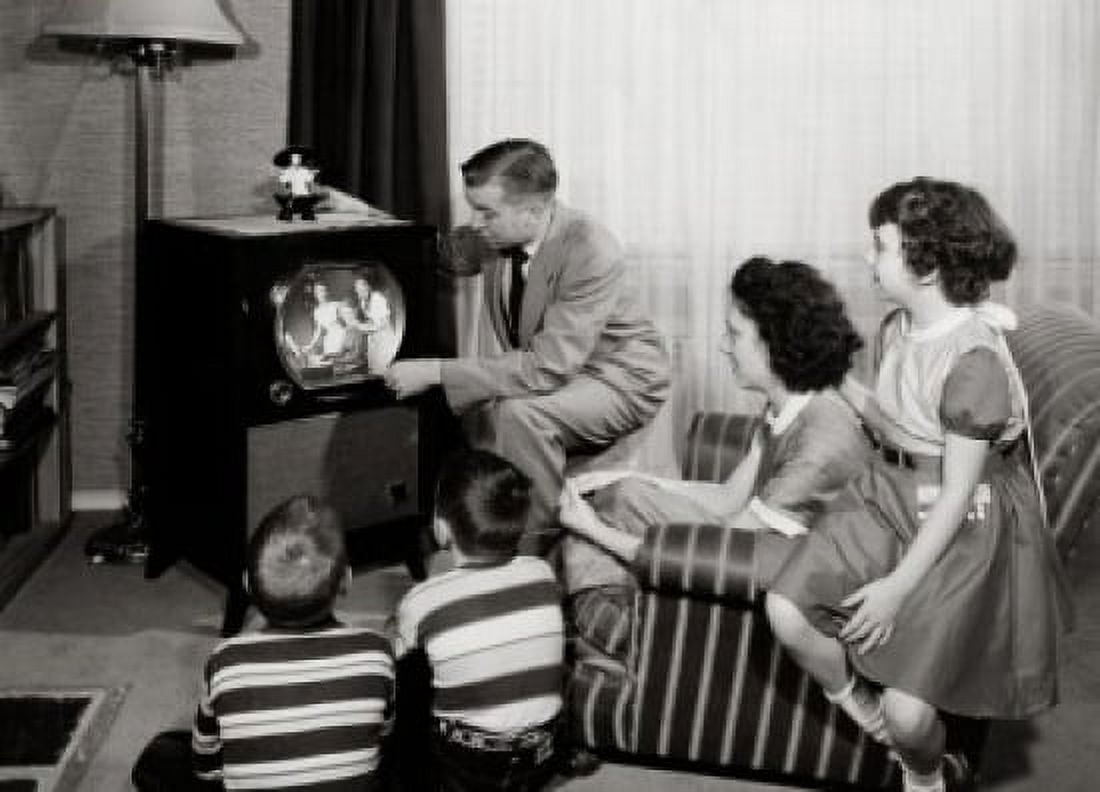 Parents with three children watching television Canvas Art - (18 x 24)