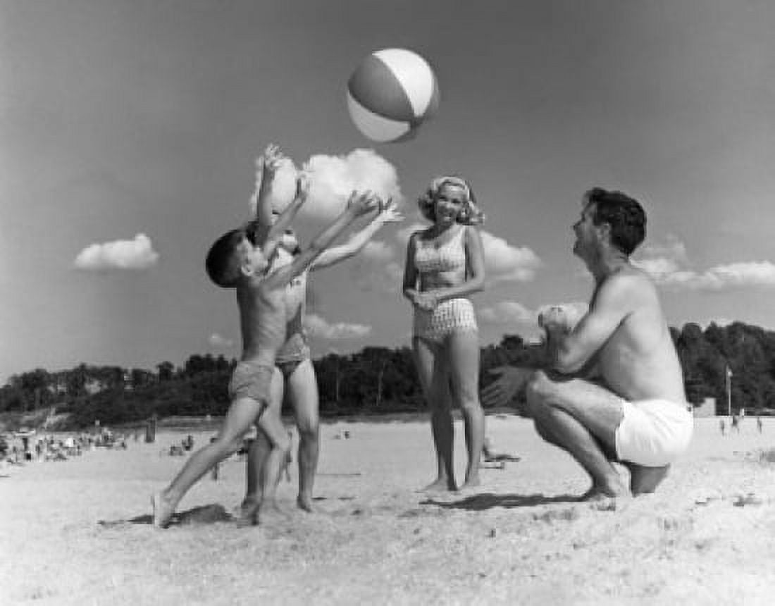 Parents with two children playing on beach Canvas Art - (18 x 24)