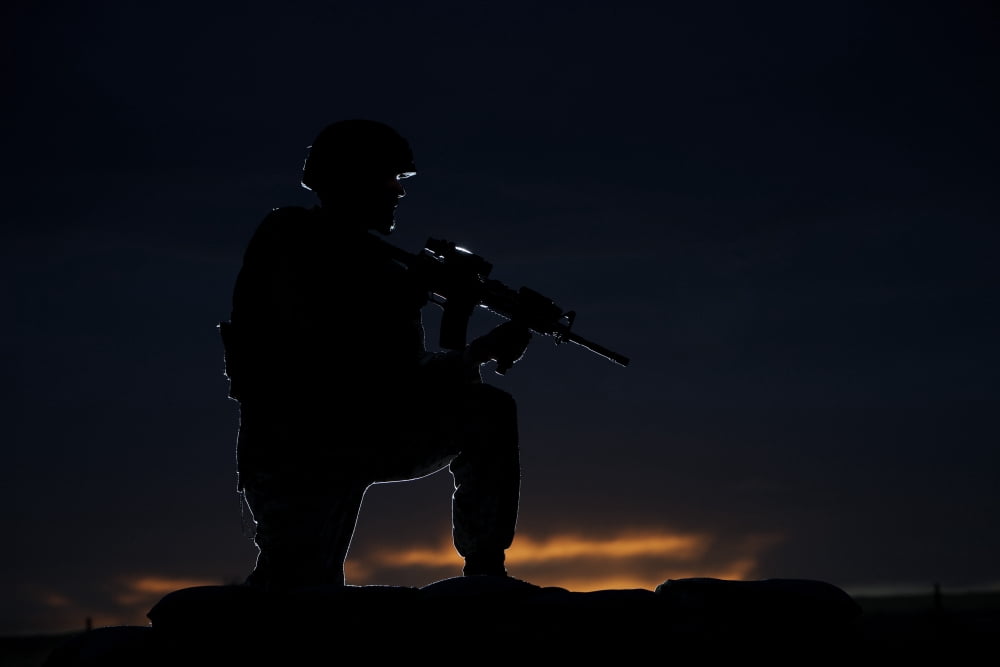 Partially silhouetted US Marine on a bunker in Afghanistan Canvas Art - Terry MooreStocktrek Images (18 x 12)