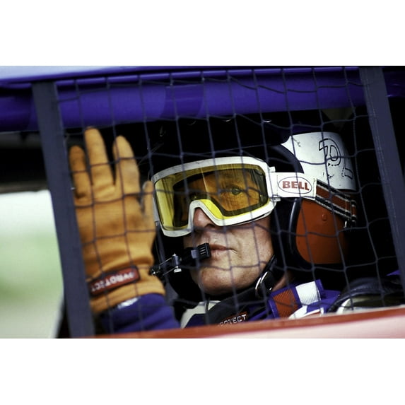 Paul Newman wearing a helmet and goggles in a racing car Photo Print (30 x 24)