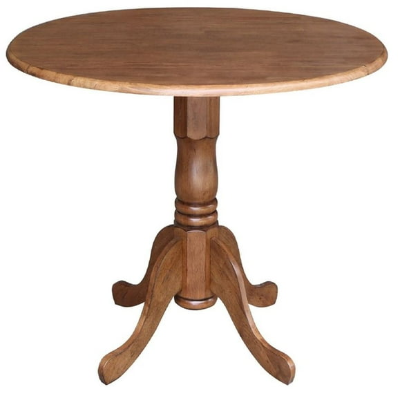 Pemberly Row 42" Round Solid Wood Dual Drop Leaf Pedestal Table in Oak Finish