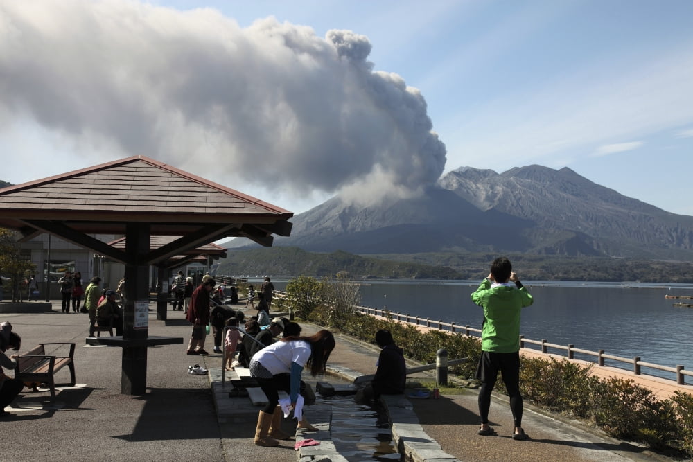 People observing eruption of Sakurajima volcano Japan Canvas Art - Richard RoscoeStocktrek Images (18 x 12)