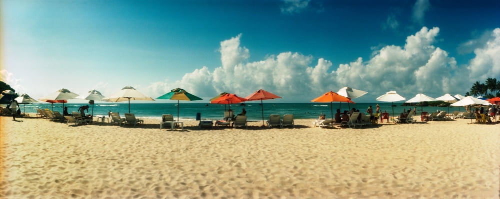 People relaxing under umbrellas on the beach Morro De Sao Paulo Tinhare Cairu Bahia Brazil Canvas Art - Panoramic Images (27 x 9)