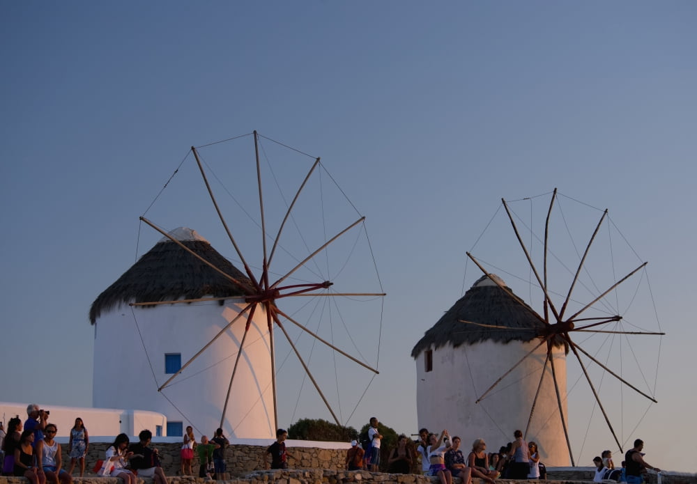 People watching the sunset beneath old windmills Mykonos Town Mykonos Cyclades Greek Islands Greece Canvas Art - Ellen Rooney Design Pics (36 x 24)