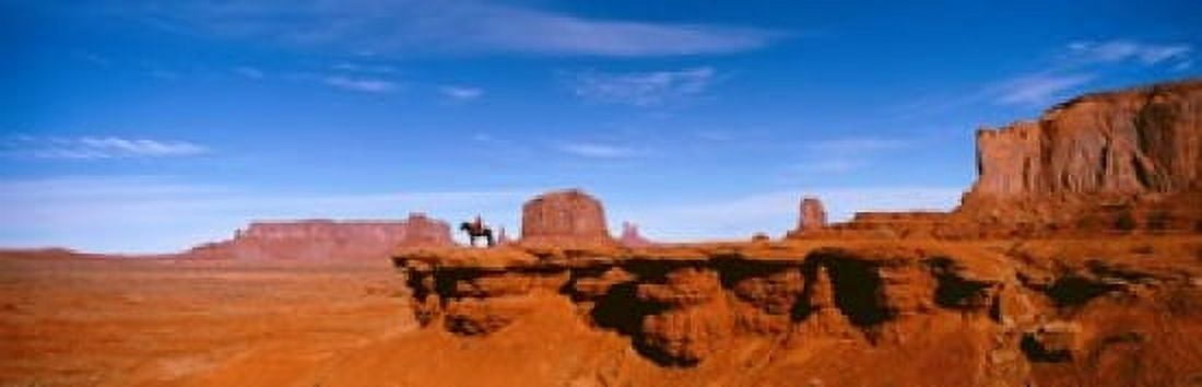 Person riding a horse on a landscape Monument Valley Arizona USA Canvas Art - Panoramic Images (18 x 6)