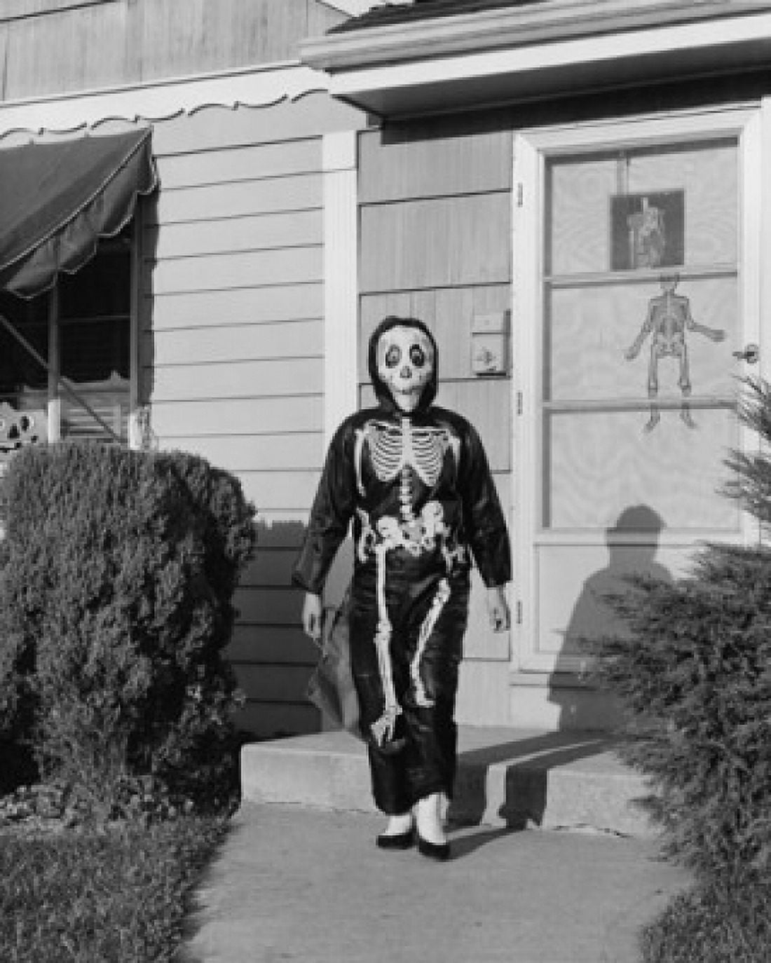 Person wearing a Halloween costume walking on a footpath outside a house Canvas Art - (18 x 24)