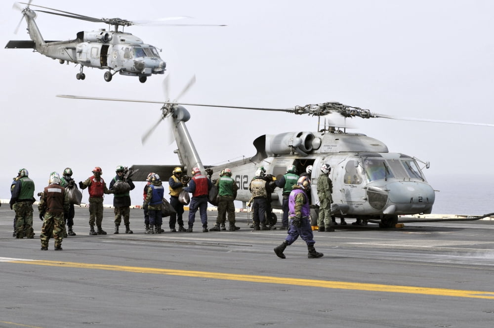 Personnel load humanitarian supplies onto an SH-60F Sea Hawk helicopter Canvas Art - Stocktrek Images (34 x 23)