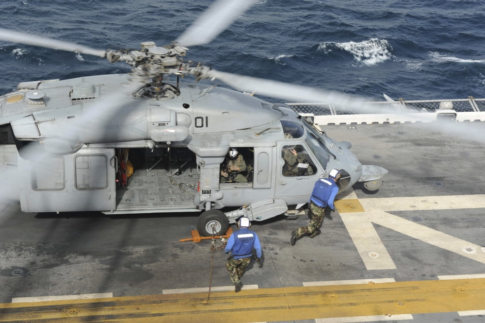 Personnel remove chock and chains from an H-60 Sea Hawk helicopter Canvas Art - Stocktrek Images (34 x 23)