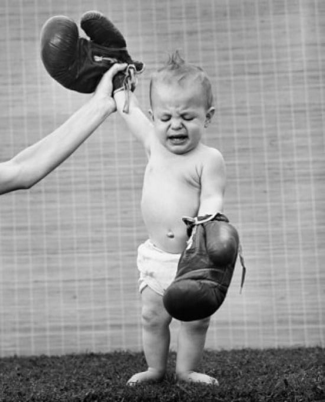 Persons hand raising a babys hand wearing boxing gloves Canvas Art - (18 x 24)